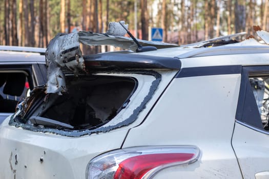 The remains of a civilian car, which was shot and destroyed by shell fragments. The actions of the Russian army during the evacuation of women and children during the Russian invasion of Ukraine