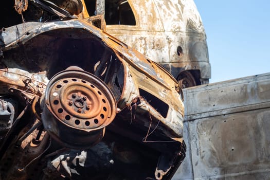 Broken and burned cars in the parking lot, accident or deliberate vandalism. Burnt car. Consequences of a car accident. Damaged by arson. Dump of civilian vehicles shot by Russian troops in Ukraine