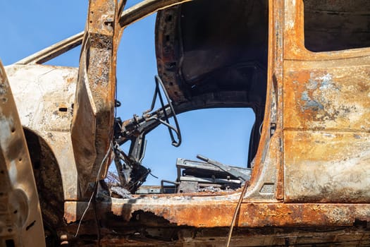 Broken and burned cars in the parking lot, accident or deliberate vandalism. Burnt car. Consequences of a car accident. Damaged by arson. Dump of civilian vehicles shot by Russian troops in Ukraine