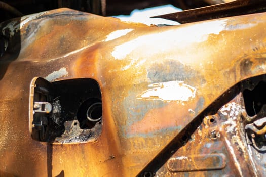 Broken and burned cars in the parking lot, accident or deliberate vandalism. Burnt car. Consequences of a car accident. Damaged by arson. Dump of civilian vehicles shot by Russian troops in Ukraine