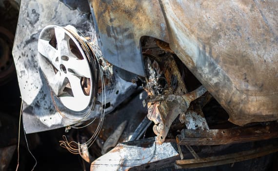 Broken and burned cars in the parking lot, accident or deliberate vandalism. Burnt car. Consequences of a car accident. Damaged by arson. Dump of civilian vehicles shot by Russian troops in Ukraine