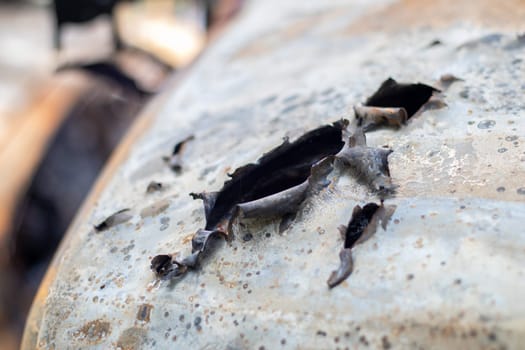 Burnt car body riddled with bullets. Russia's war against Ukraine. Shot by the Russian military car of civilians during the evacuation. Traces of bullets and fragments of shells