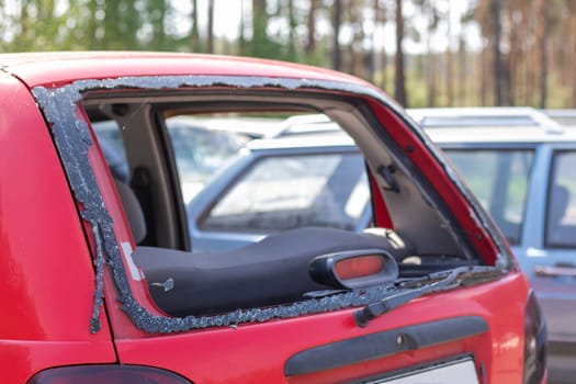 A car after an accident with a broken rear window. Broken window in a vehicle. The wreckage of the interior of a modern car after an accident, a detailed close-up view of the damaged car