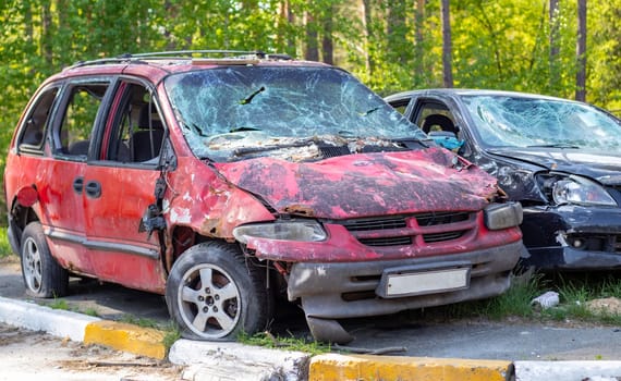 A car destroyed by shrapnel from a rocket that exploded nearby. Irpensky automobile cemetery. Consequences of the invasion of the Russian army in Ukraine. Destroyed civilian vehicle