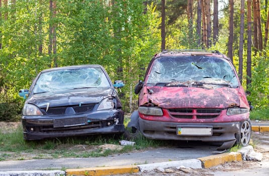 A car destroyed by shrapnel from a rocket that exploded nearby. Irpensky automobile cemetery. Consequences of the invasion of the Russian army in Ukraine. Destroyed civilian vehicle