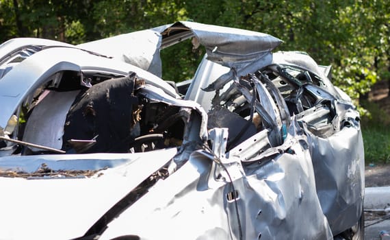 The remains of a civilian car, which was shot and destroyed by shell fragments. The actions of the Russian army during the evacuation of women and children during the Russian invasion of Ukraine