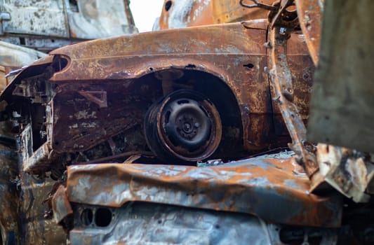 Broken and burned cars in the parking lot, accident or deliberate vandalism. Burnt car. Consequences of a car accident. Damaged by arson. Dump of civilian vehicles shot by Russian troops in Ukraine
