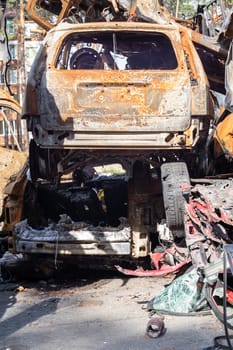 A lot of rusty burnt cars in Irpen, after being shot by the Russian military. Russia's war against Ukraine. Cemetery of destroyed cars of civilians who tried to evacuate from the war zone