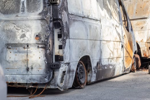 A lot of rusty burnt cars in Irpen, after being shot by the Russian military. Russia's war against Ukraine. Cemetery of destroyed cars of civilians who tried to evacuate from the war zone