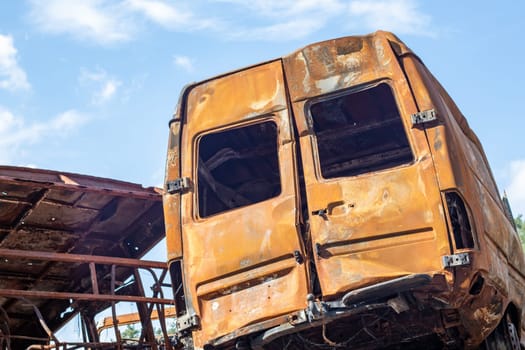 A lot of rusty burnt cars in Irpen, after being shot by the Russian military. Russia's war against Ukraine. Cemetery of destroyed cars of civilians who tried to evacuate from the war zone
