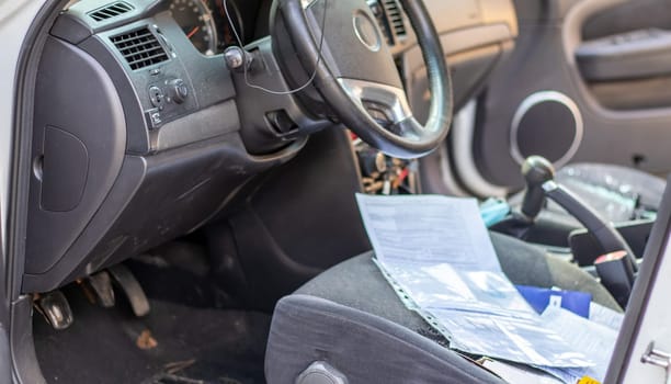 Close-up of the steering wheel of a car after an accident. The driver's airbags did not deploy. Soft focus. Broken windshield with steering wheel. Vehicle interior. Black dashboard and steering wheel