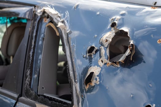 Car riddled with bullets. War of Russia against Ukraine. A car of civilians shot by the Russian military during the evacuation of women and children. Traces of bullets and fragments of shells