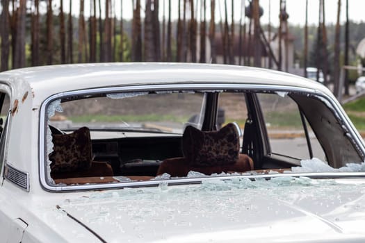 A car after an accident with a broken rear window. Broken window in a vehicle. The wreckage of the interior of a modern car after an accident, a detailed close-up view of the damaged car