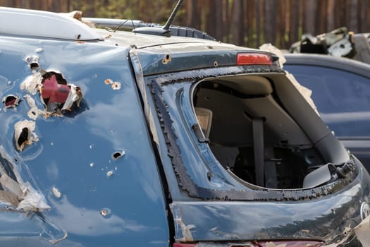 Car riddled with bullets. War of Russia against Ukraine. A car of civilians shot by the Russian military during the evacuation of women and children. Traces of bullets and fragments of shells