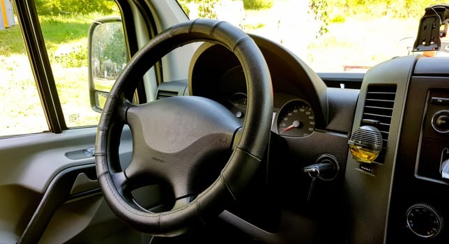 Close-up of the dashboard, speedometer, tachometer and steering wheel. Modern car interior. Internal cabin. Vehicle interior. Close shot of car dashboard