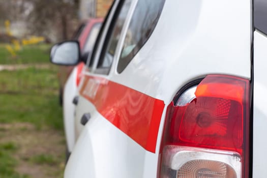 The rear left lamp of a white car is broken. The taillight of the car was shattered in the accident. Damage accident. Security concept. Rear stop of a car in an accident close-up