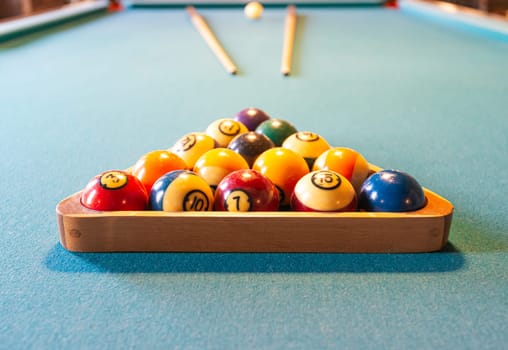 Billiard table with balls and cues