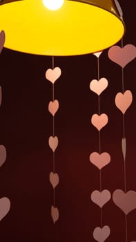 Flying red paper hearts on red dark background. Valentines Day. Symbol of love. beautiful flying pink hearts. Happy Valentines Day. Hearts under Lamp. Full of Love. 4k 400mb s. Love day.