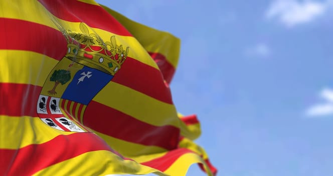 Aragonese flag waving in the wind on a clear day. Aragon is an autonomous community in Spain, coextensive with the medieval Kingdom of Aragon