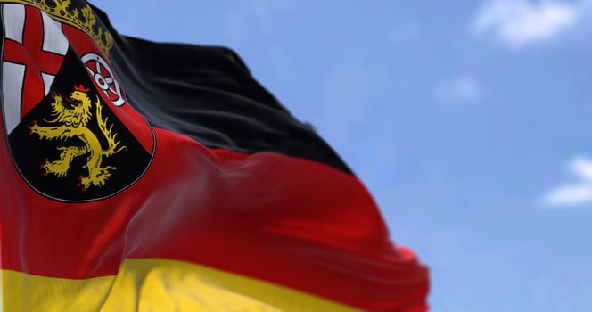 The flag of Rhineland-Palatinate waving in the wind on a clear day. Rhineland-Palatinate is a German state (Land) situated in western Germany