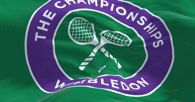 London, UK, April 2022: Close up of The Championships Wimbledon flag waving in the wind. Wimbledon Championships is a major tennis tournament scheduled in late June each year