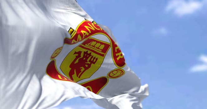 Manchester, UK, May 2022: The flag of Manchester United waving in the wind on a clear day. Manchester United is a professional football club based in the Old Trafford area of Manchester, England