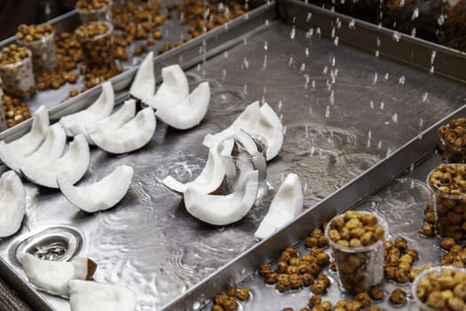 Detail of coconut pieces and dried tiger nuts at a fair, healthy food