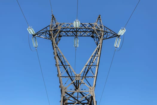 Electric poles and lines high voltage on a blue sky background.