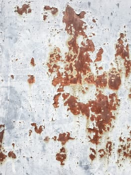 Rusted white metal wall with cracks on paint, background texture.