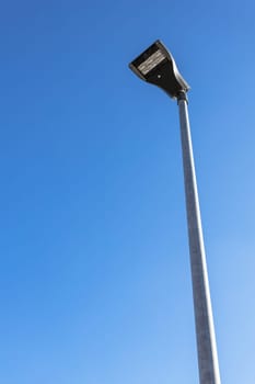 Modern street LED lighting pole. Urban electro-energy technologies. Poles on the road with LED light. Outdoor lighting strong LED lamp.