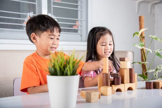 Happy little kids play wood block stacking board game at home, Children boy and girl playing with constructor wooden block, childhood activities learning creative, toys for preschool and kindergarten