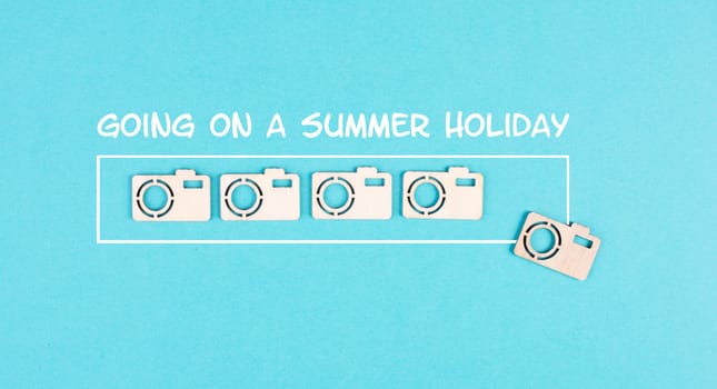 Progress bar with cameras on a blue paper, planning a trip for the weekend, vacation and travel concept, photographer