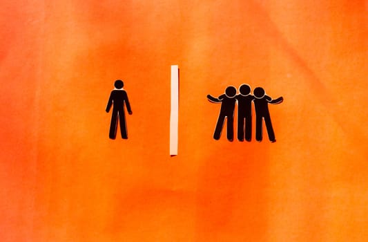 Paper man standing Isolated from group. Feel Left out and alone. Social isolation and Rejection concepts.