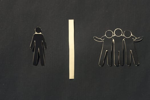 Paper man standing Isolated from group. Feel Left out and alone. Social isolation and Rejection concepts.