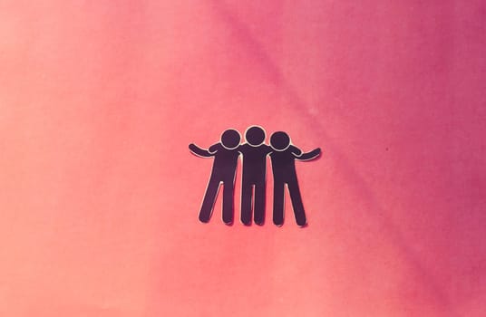Paper cut happy friends with hand on shoulder in color background. Concept of friendship, help, support, love and togetherness.