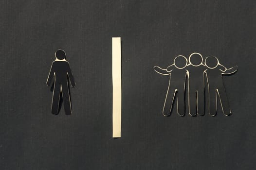 Paper man standing Isolated from group. Feel Left out and alone. Social isolation and Rejection concepts.
