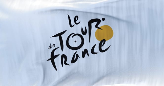 Paris, France, June 2022: Flag with the Tour de France logo waving. The Tour de France is the most important cycling event of the year and one of the most important sporting events in the world