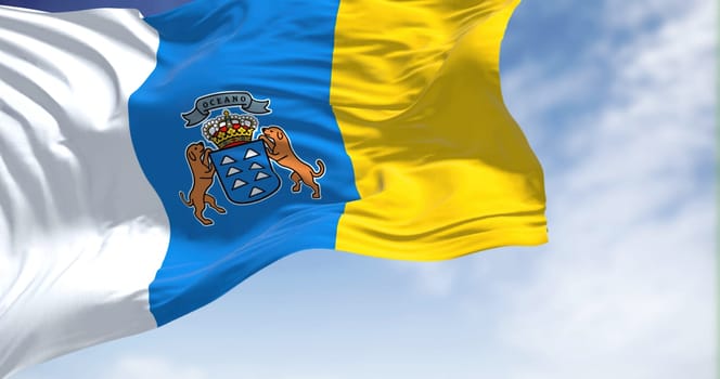 The Canary Islands flag waving in the wind on a clear day. The Canary Islands are a Spanish region and archipelago in the Atlantic Ocean, in Macaronesia