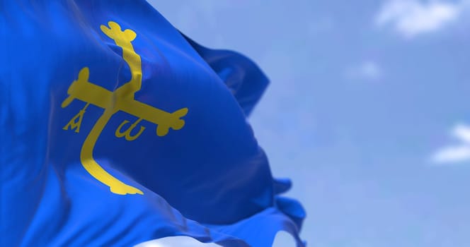 Rear view of the Asturias flag waving in the wind on a clear day. Asturias is an autonomous community in northwest Spain