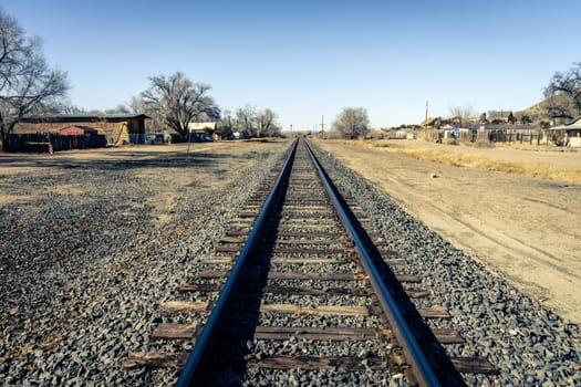Railroad line through a small town of Los Cerillos in New Mexico
