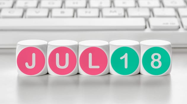 Letter dice in front of a keyboard - July 18