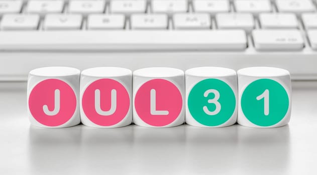 Letter dice in front of a keyboard - July 31