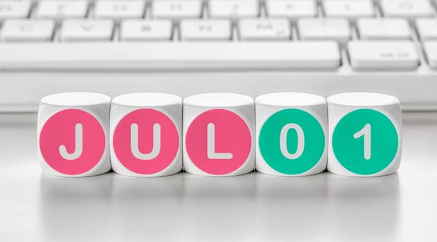 Letter dice in front of a keyboard - July 01
