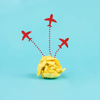 Red airplanes flying out of a crumpled yellow paper, brainstorming for ideas in a team, startup in business, having a goal, positive mindset