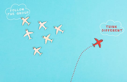Airplanes following the group, red plane thinks different and takes the opposite direction, leadership, courage and winner concept