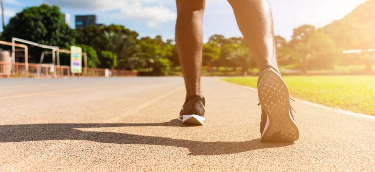 Asian young athlete sport runner black man wear feet active ready to running training at the outdoor on the treadmill line road for a step forward, healthy exercise workout, closeup back shoe