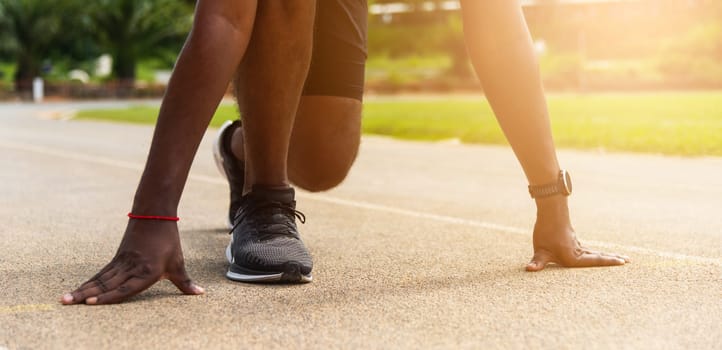 Asian young athlete sport runner black man wear feet shoe active ready to start running training at the outdoor on the treadmill for a step forward, healthy exercise workout, closeup face front