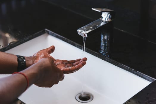 Closeup washing black man hands rubbing with soap and water in sinks to prevent outbreak coronavirus hygiene to stop spreading virus, hygiene for quarantine cleaning COVID-19 concept