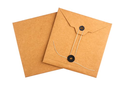 top view closeup two of closed square vintage craft paper envelopes with textile thread enclosing isolated on white background