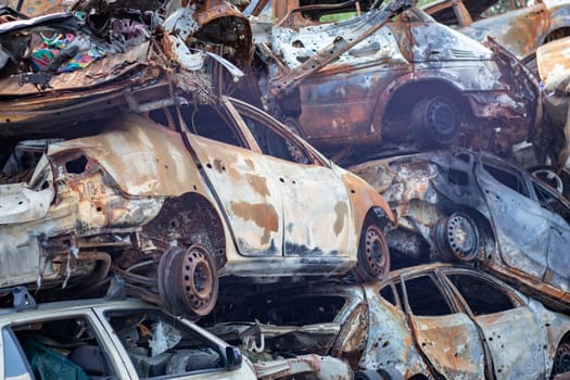 Russian invasion of Ukraine in 2022, destroyed and burned cars. Cars were beaten with shrapnel and burned. Irpensky automobile cemetery. The consequences of the war in a peaceful city near Kyiv